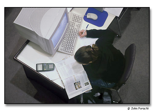 Student working at night in library. <br>Geisel Library, Saint Anselm College, Manchester, New Hampshire. October 2002.