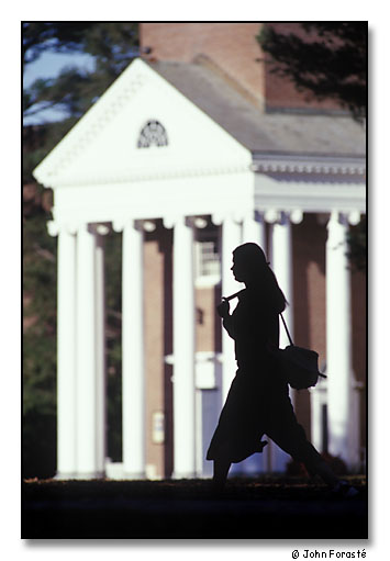 Student crossing green between classes. <br>Cole Memorial Chapel, Wheaton College, Norton, Massachusetts. November 1999.
