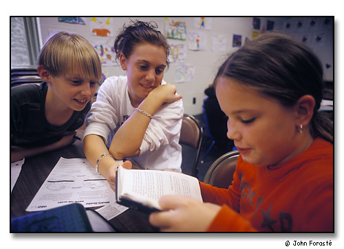 A Saint Anselm College student tutors girls after school. <br>Girls Inc in downtown Manchester, New Hampshire. October 2002.