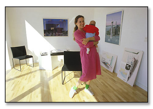Laurinda Spear with her baby in her architectural studio. <br>Co-founder of the very successful firm, Arquitectonica, in Miami, Florida.<br>Photograph made for feature story in the Brown Alumni Magazine. February 1987.