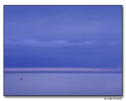 Water, sky and sailboat at dusk, off Acadia National Park, Maine. September 2001.