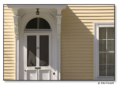 Sun on yellow house.
