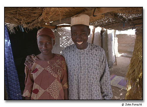 Young couple, Mahamma Bello & Amma (his wife of a few months) outside their house. Mora, Cameroon, (central west) Africa. August 2002.